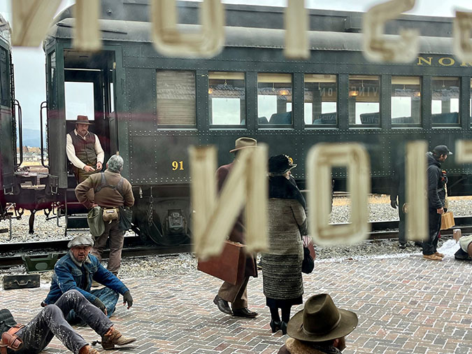 Brandon Sklenar, who plays Spencer Dutton, stands on the train in between takes   Brandon Sklenar, who plays Spencer Dutton, stands on the train in between takes