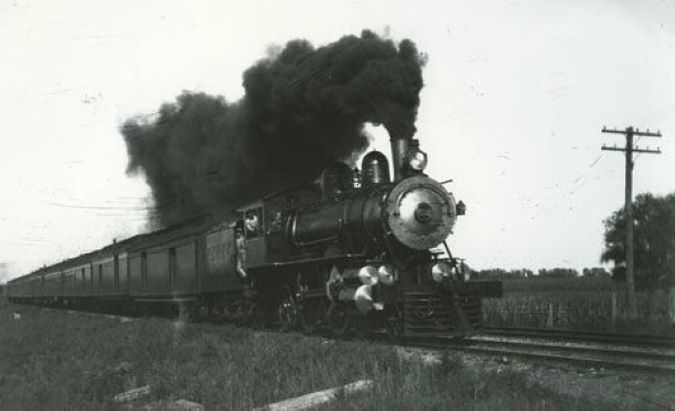 A CB&Q train travelling at full speed toward Chicago  A CB&Q train travelling at full speed toward Chicago