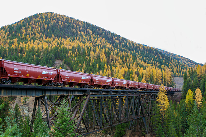 A grain train crosses the Java Trestle at Glacier National Park near Essex, Montana.