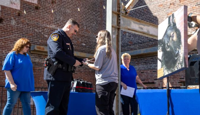 K-9 Faust is honored at the We Ride to Provide (WRTP) K-9 Memorial. His handler, BNSF Senior Special Agent Bryan Schaffer, accepts the award.  K-9 Faust is honored at the We Ride to Provide (WRTP) K-9 Memorial. His handler, BNSF Senior Special Agent Bryan Schaffer, accepts the award.